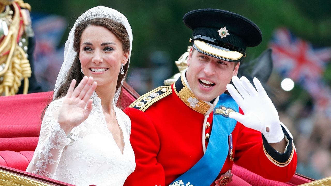 Catherine, Duchess of Cambridge and Prince William, Duke of Cambridge travel down The Mall, on route to Buckingham Palace, in the 1902 State Landau horse drawn carriage following their wedding ceremony at Westminster Abbey on April 29, 2011 in London, England