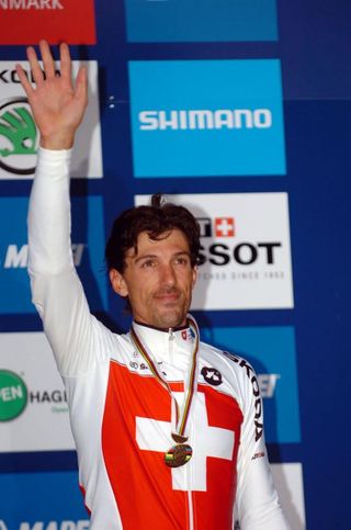 Fabian Cancellara waves to the crowd after taking the bronze
