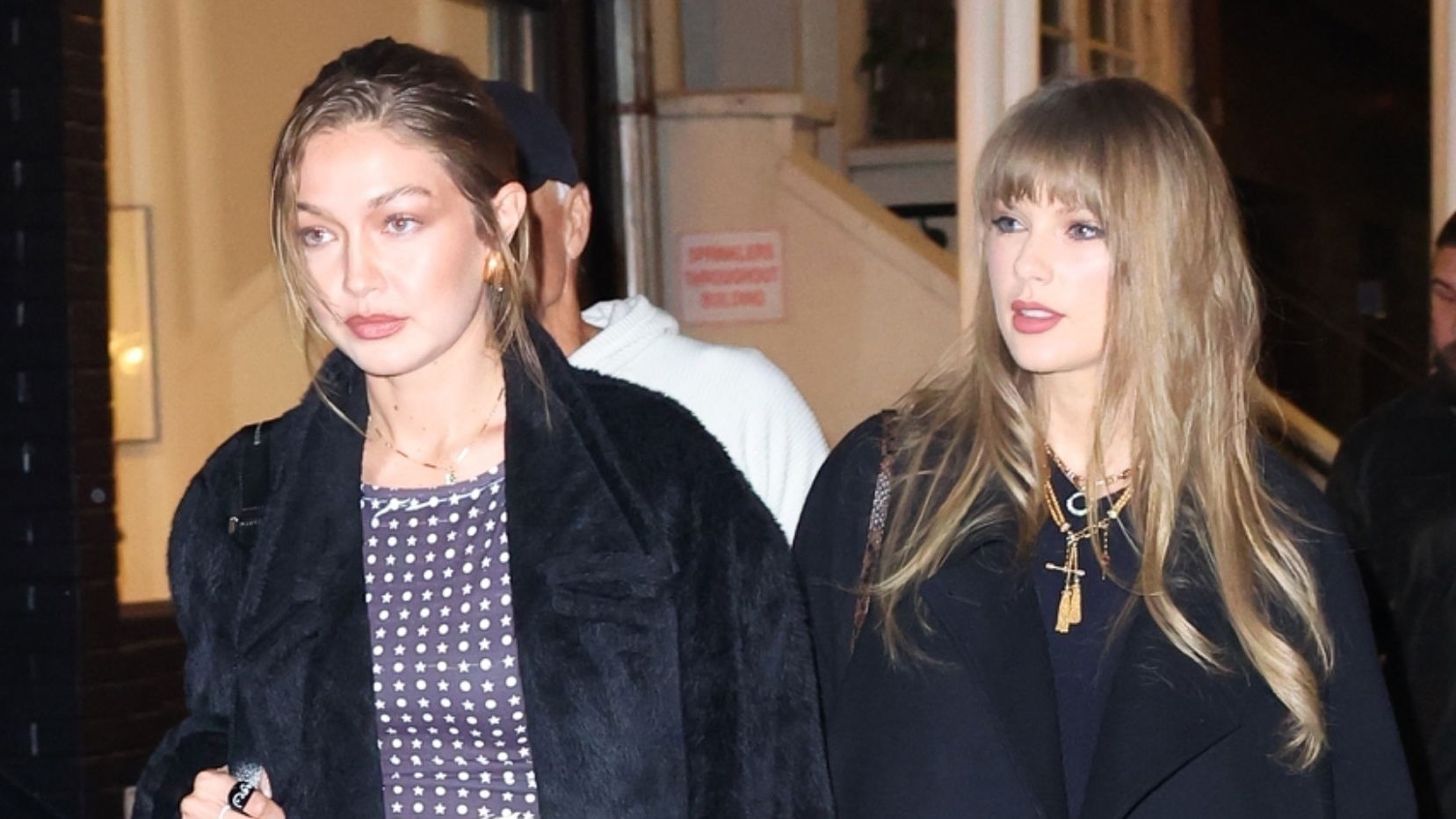 Gigi Hadid and Taylor Swift wearing black coats to go to Zero Bond in NYC