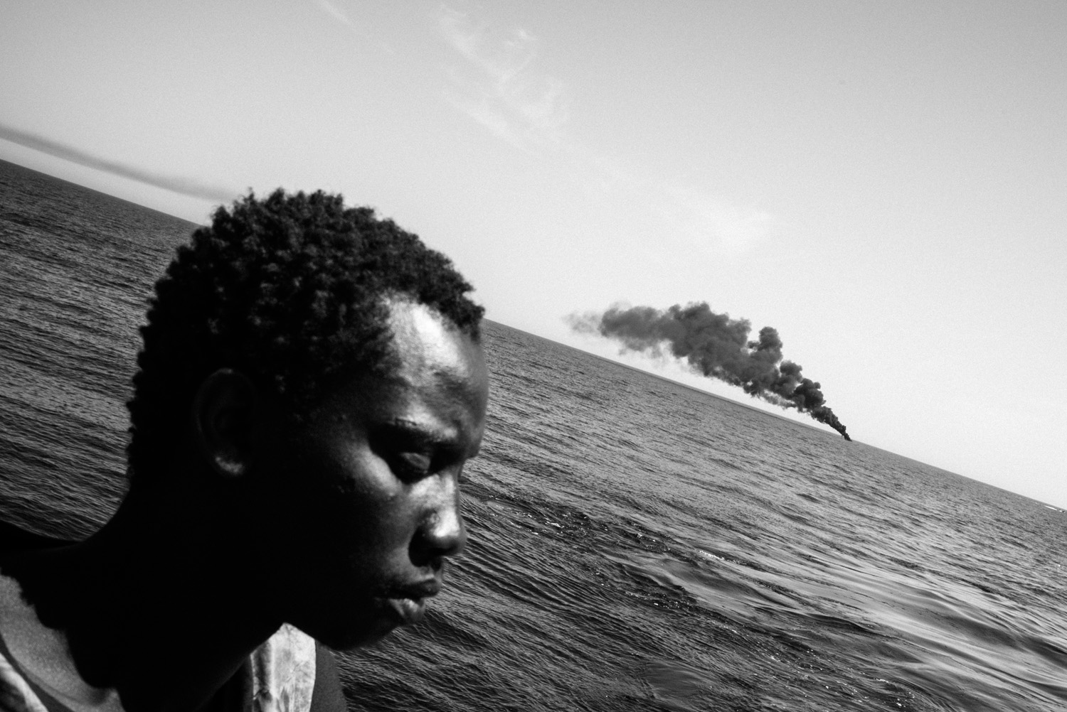 SOS Méditerranée, Aquarius, on the Mediterranean Sea between Libya and Italy 2016After the rescue, the migrants’ boat was pulled away and burned to prevent it from drifting or being reused by smugglers/ Édouard Elias: Eyewitness/Leica Gallery Wetzlar