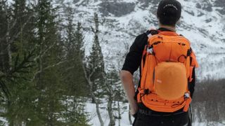 Man wearing POC Dimension Avalanche Backpack