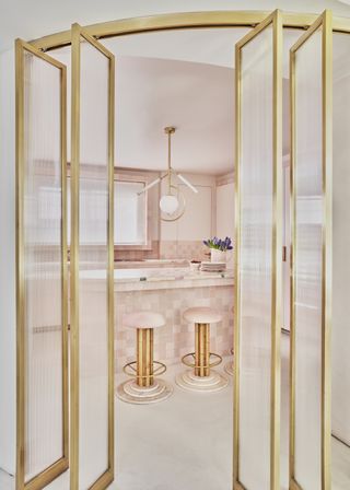 A kitchen drenched in pink and gold