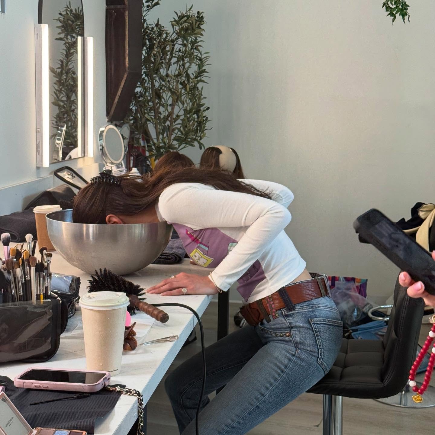 Bella Hadid doing an ice water facial on set