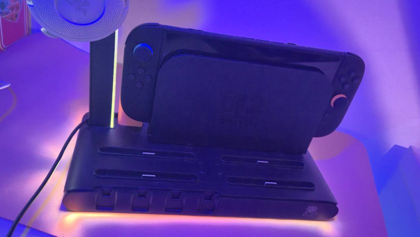 Photo of the charging stand lit up in the dark, with its LED lighting glowing around the base.