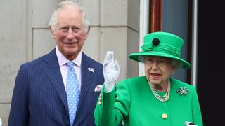 Prince Charles and Queen Elizabeth stand on a balcony during the Platinum Jubilee Pageant
