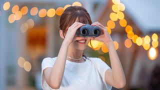 Best image stabilized binoculars: woman holding Canon IS 8x20 binos