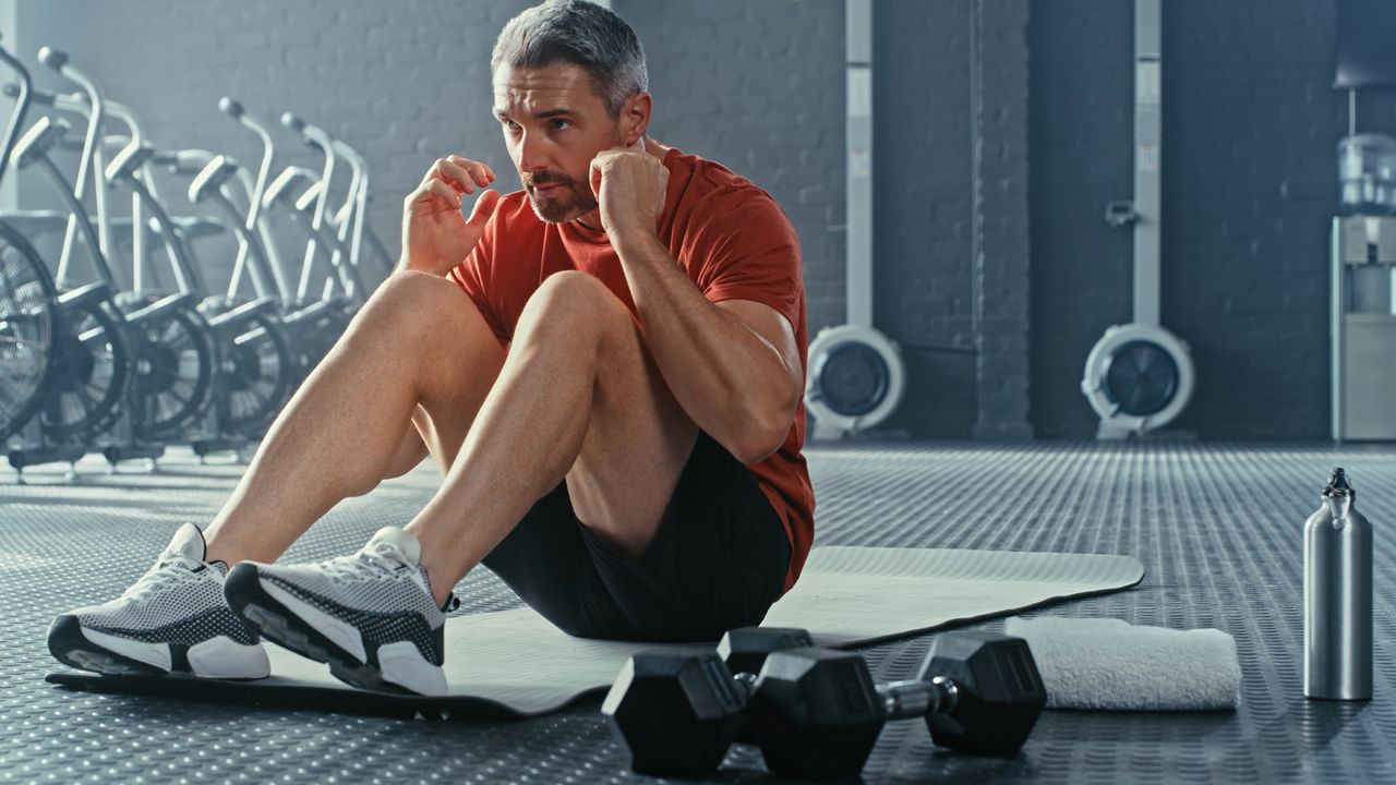 Man completing a dumbbell ab workout