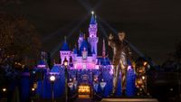 Partners statue and Sleeping Beauty Castle at night