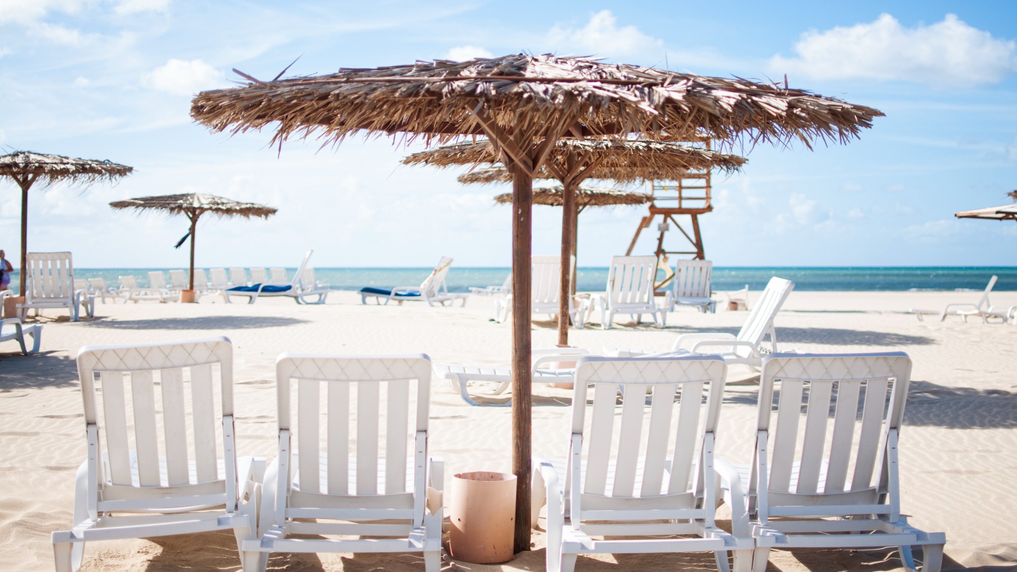 A parasol and sun loungers on a beach in Cape Verde