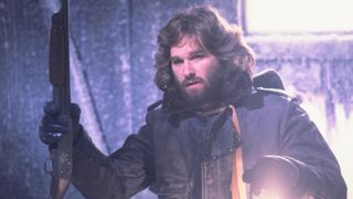 Kurt Russell as R.J. MacReady holding a shotgun during the horror movie, The Thing.