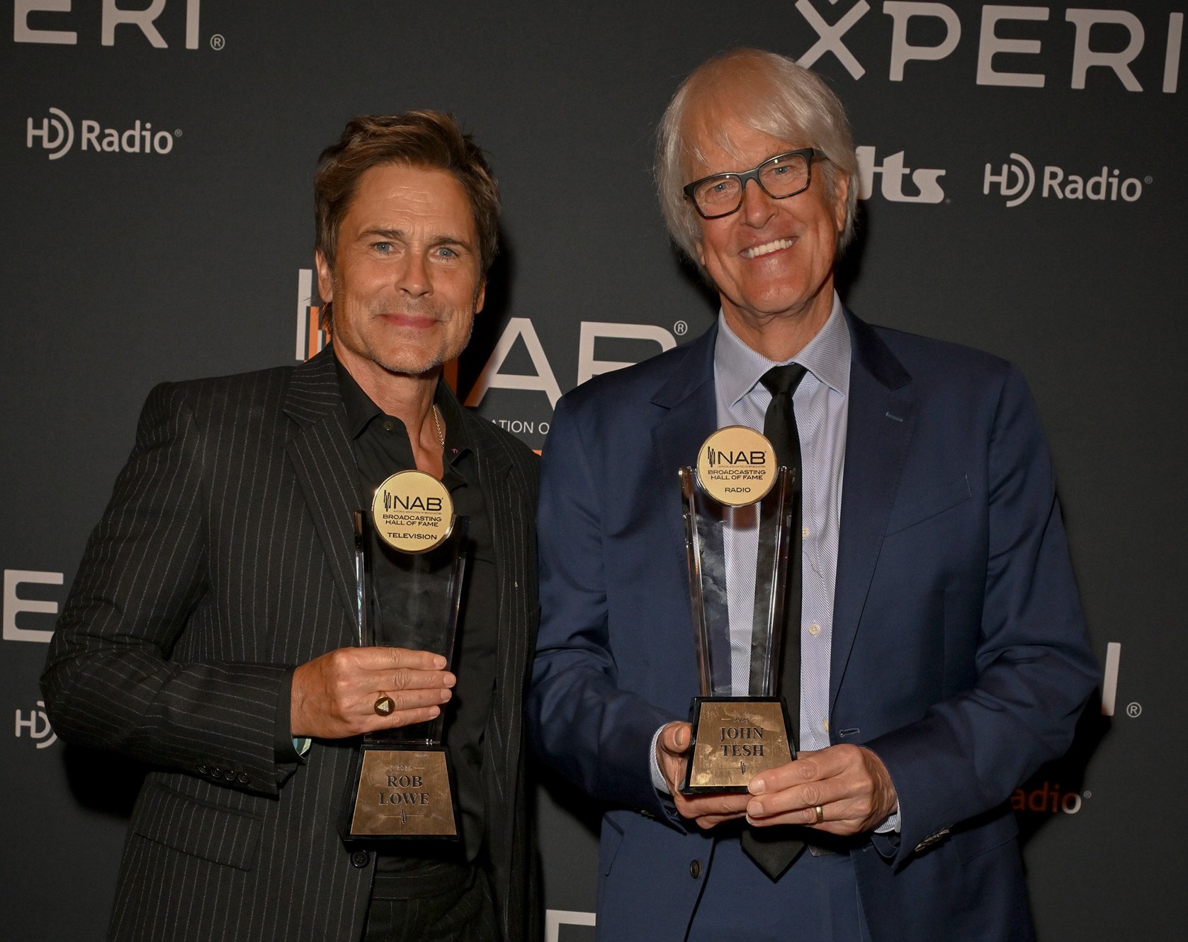Rob Lowe (left), John Tesh with trophies 