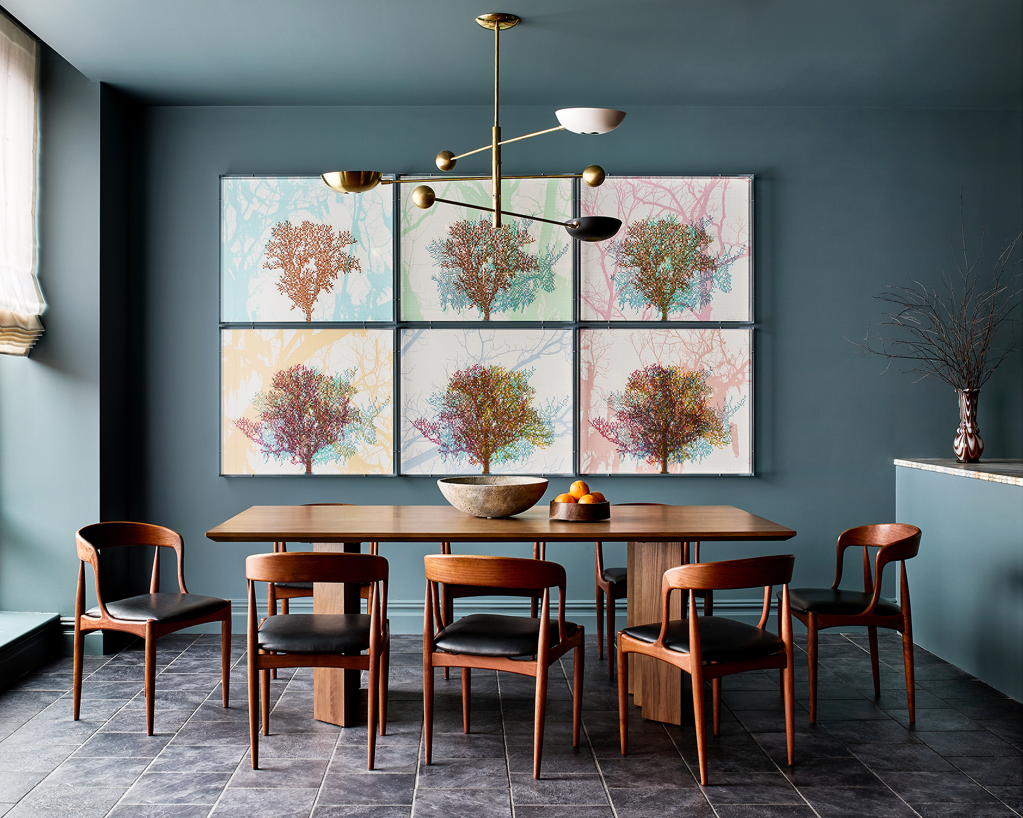 blue dining room with art on the walls