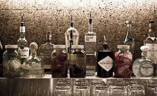 bottles of spirits on a bar shelf at The Keefer Hotel, Vancouver