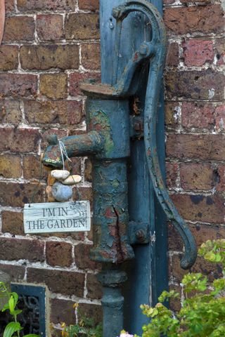antique water pump in a cottage garden