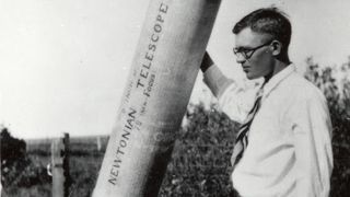 A black and white photo of a man with glasses next to a telescope that says "Newtonian Telescope."