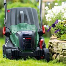 Bosch lawnmower on grass in garden