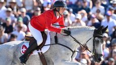 Martin Fuchs jumping at the Paris Olympics.