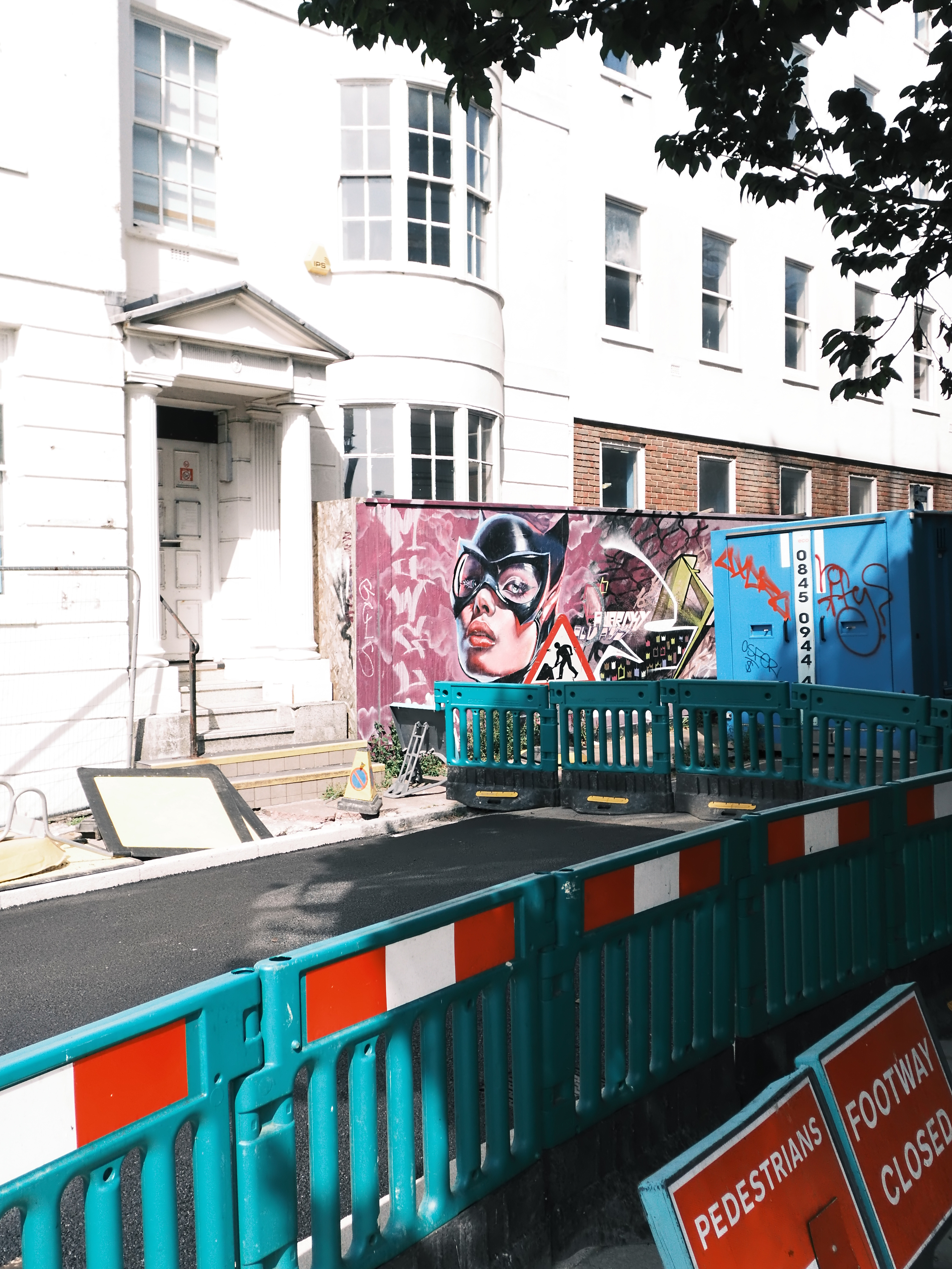 A graffiti wall next to some roadworks