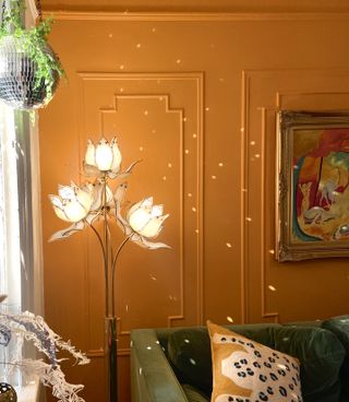 Orange living room with a statement glass flower lamp
