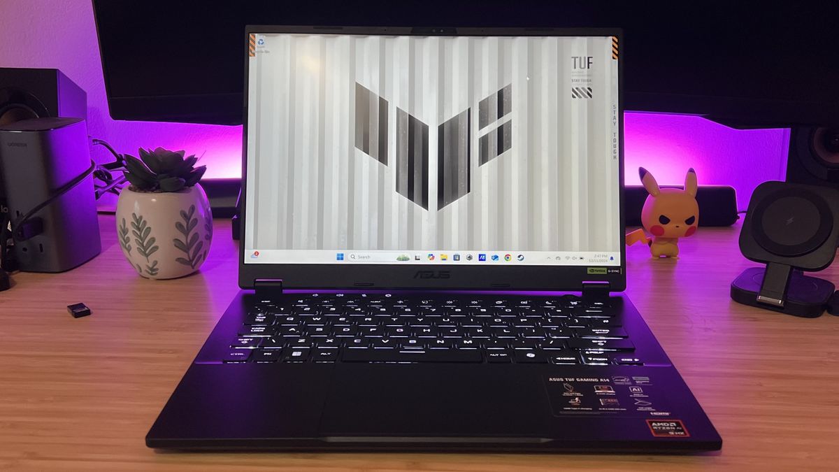 Asus TUF A14 gaming laptop on a wooden desk