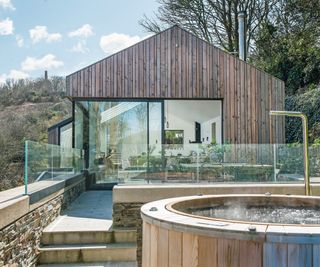 Wooden exterior, hot tub with gold tap