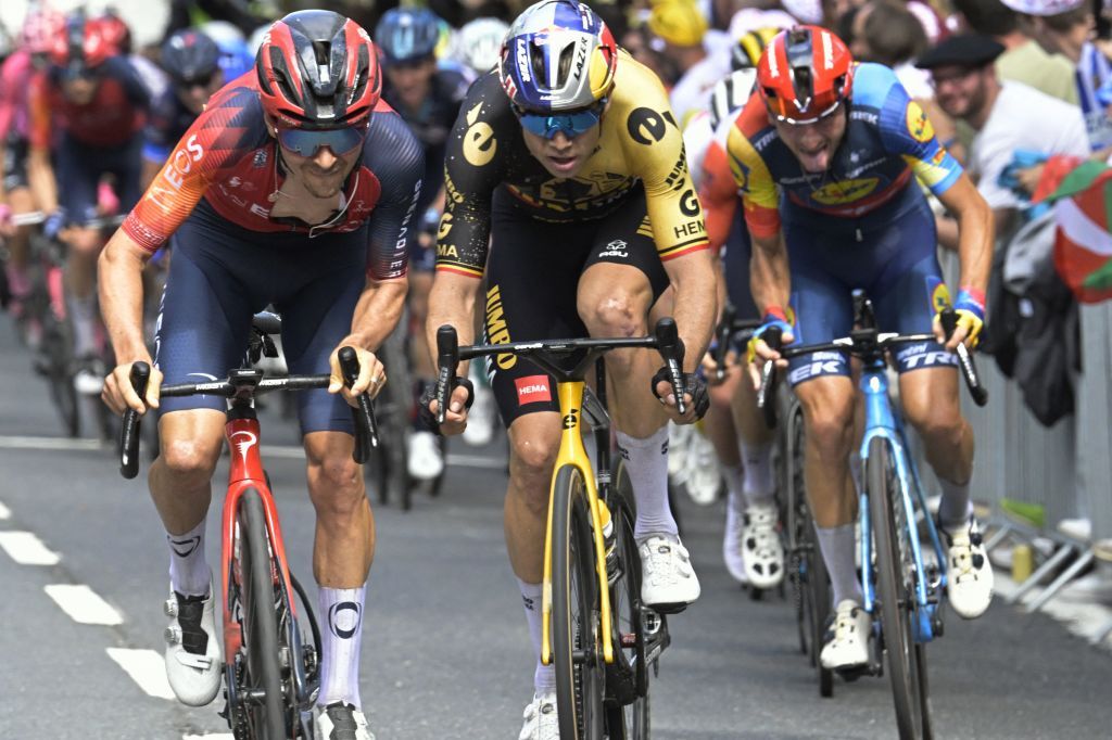 Ineos Grenadiers&#039; Tom Pidcock accelerates ahead of Wout van Aert (Jumbo-Visma) during the second stage of the Tour de France 