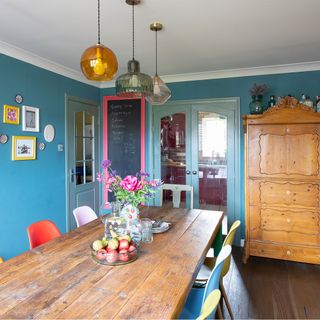 blue dining room with wooden table and cabinet