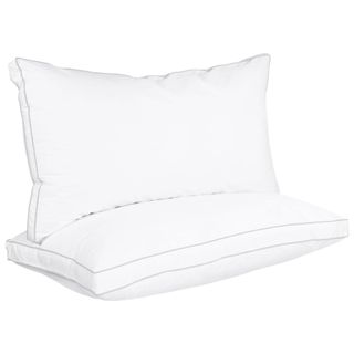 Two white pillows stacked on top of eachother