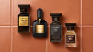 A selection of Tom Ford perfumes on a tiled background.