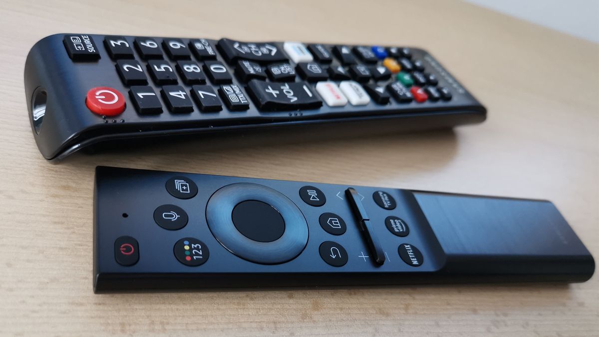 Two remotes for Samsung QN95A sitting on wood surface