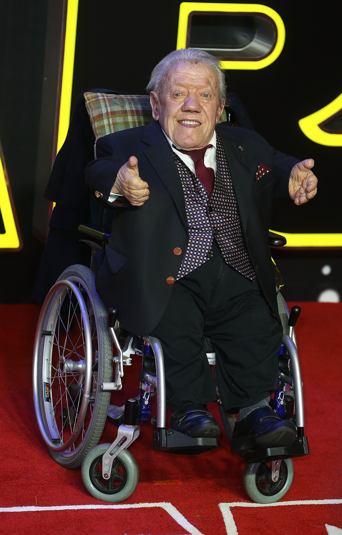 Kenny Baker attends the european premiere of Star Wars: The Force Awakens 2015. He passed in 2016.