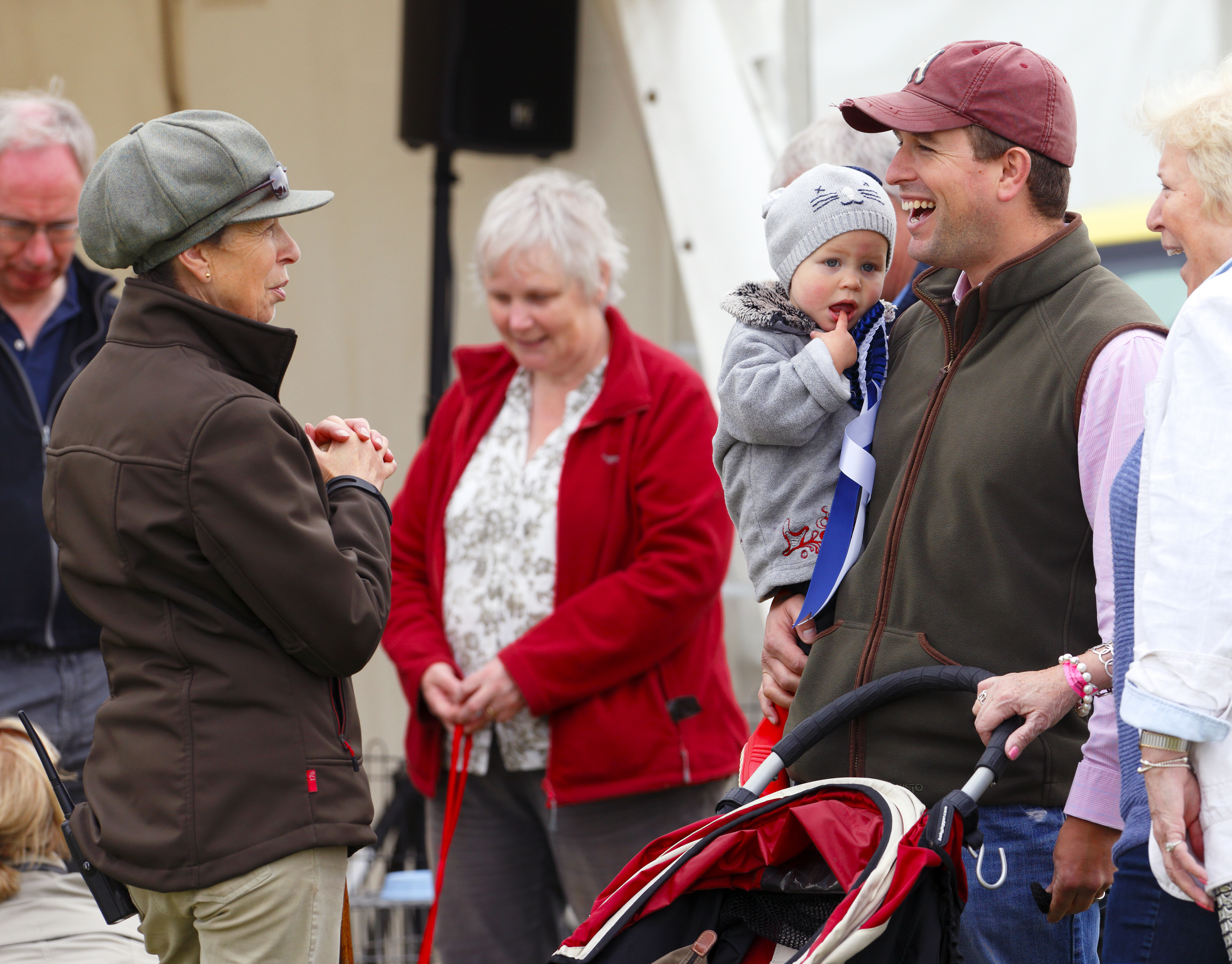 Princess Anne and Peter Phillips laughing as he holds daughter Isla