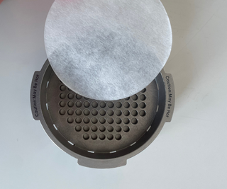 Aeropress Premium paper filter in the stainless steel cap