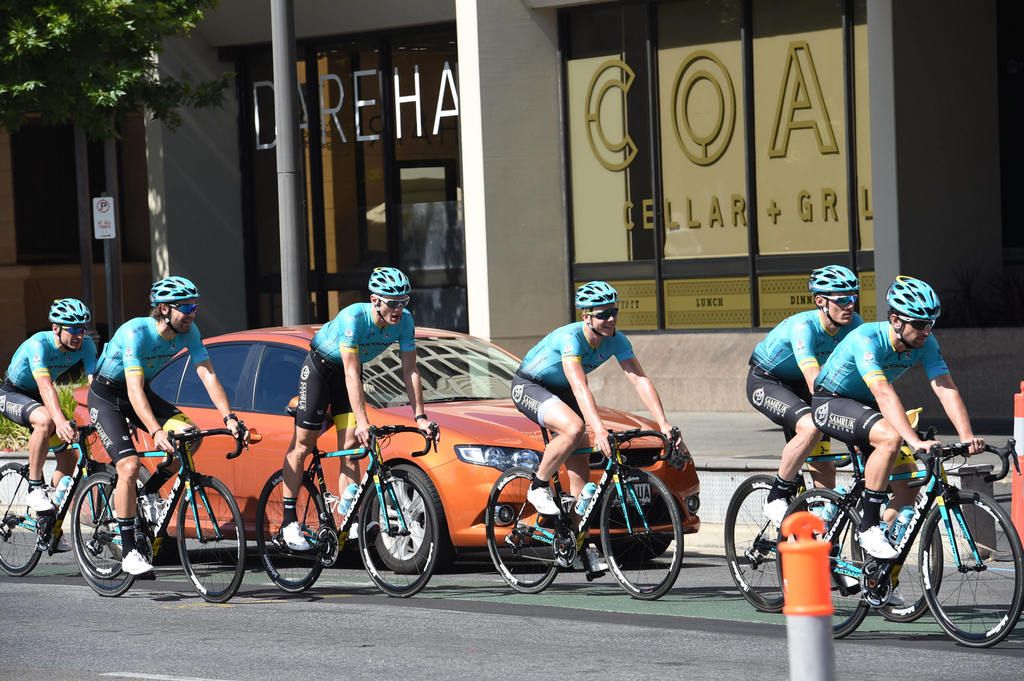 The Astana team ride past race headquarter at the Hilton Hotel