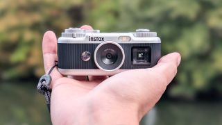 A black and silver Fujifilm Instax Pal 2 digital camera
