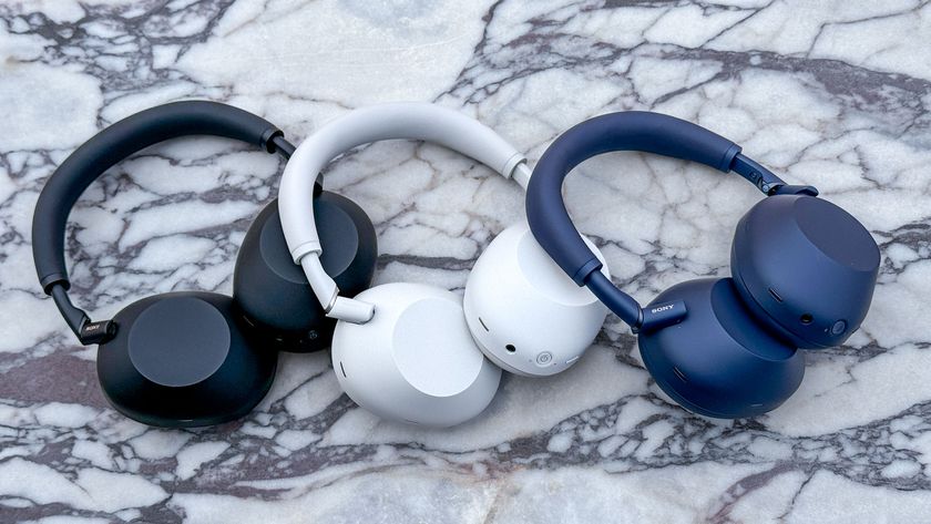 Black, white and blue models of the Sony WH-1000XM6 noise-cancelling headphones on a marble table