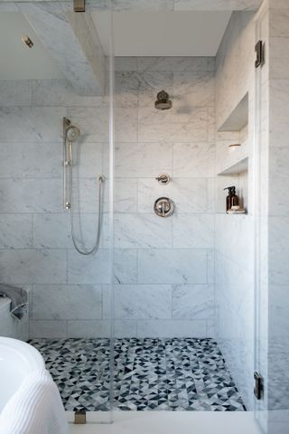 white shower with stainless steel hardware