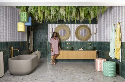 Purple and white patterned tiles and green tiles, plants draping from ceiling 