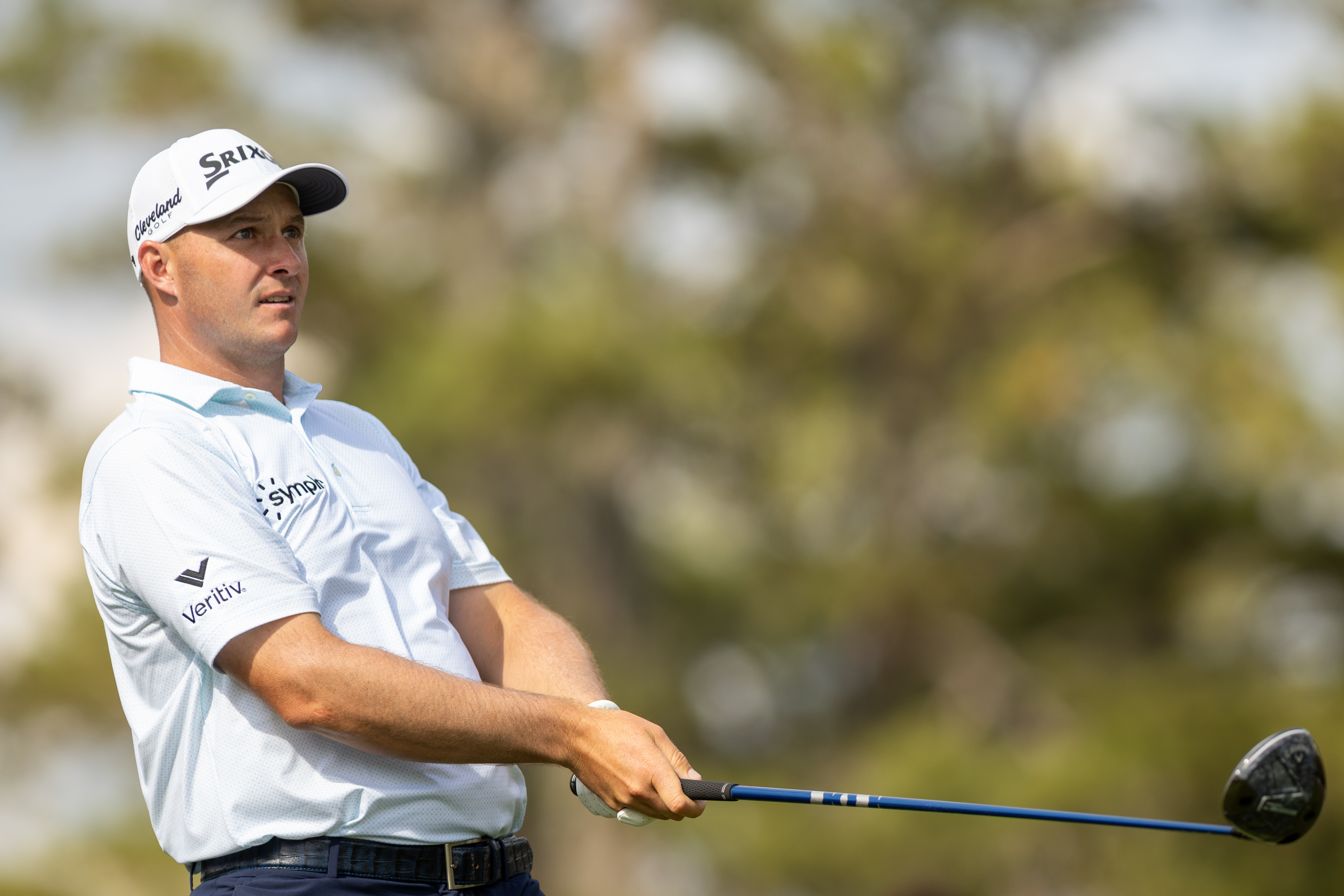 Sepp Straka watches his tee shot holding a driver