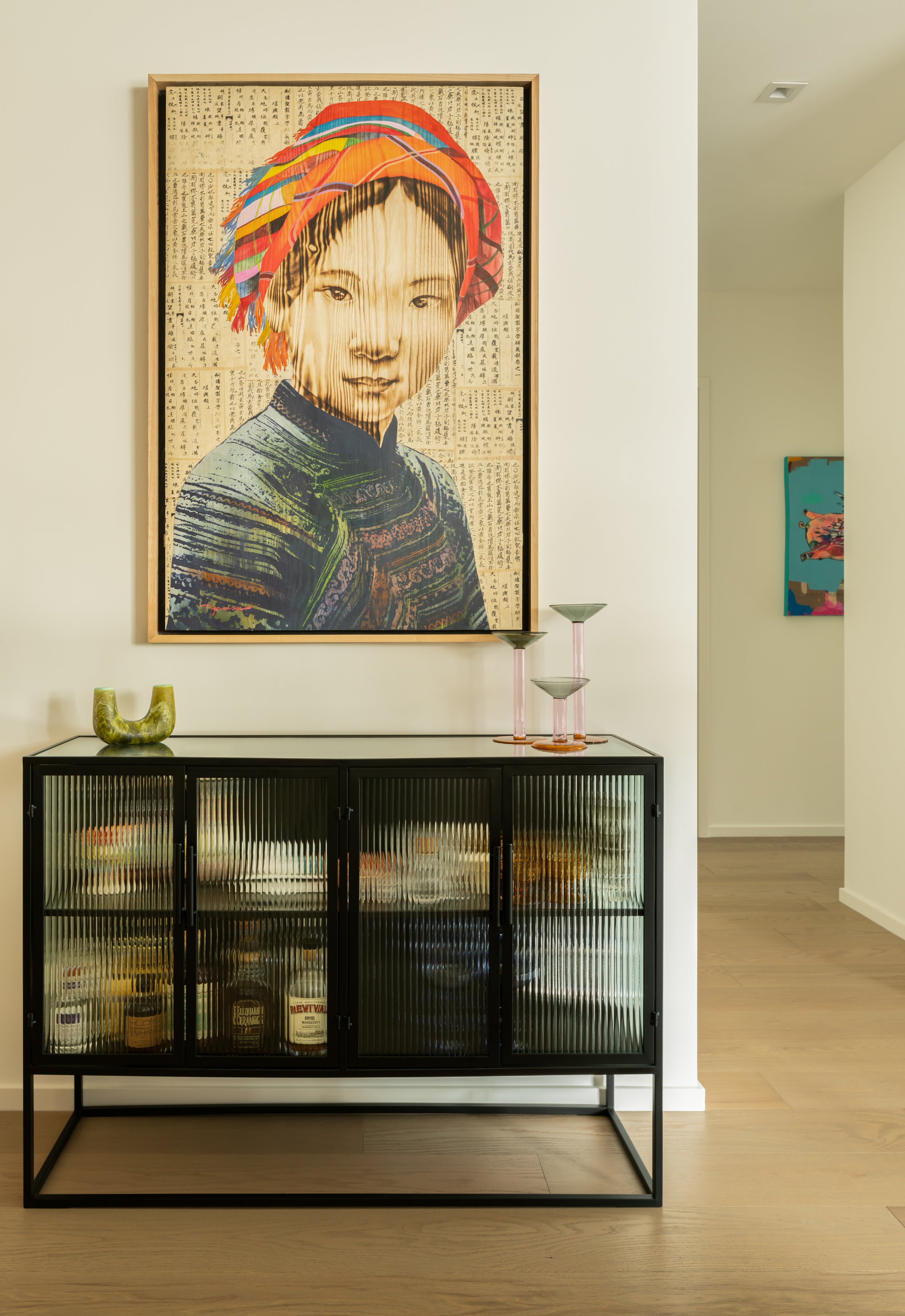 A cabinet with fluted glass fronts in a contemporary hallway