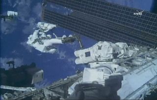 NASA astronaut Ricky Arnold works to replace a camera assembly at the International Space Station during a spacewalk with NASA astronaut Drew Feustel on May 16, 2018.