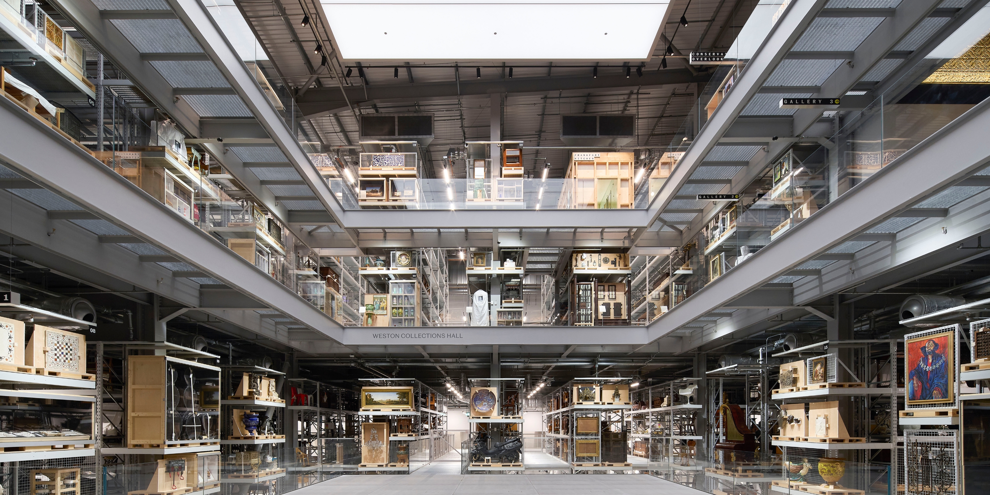 A back-lit, retro-inspired warehouse houses the centuries-spanning collection of a museum.