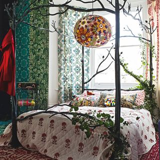 floral bedroom with tree themed four poster bed