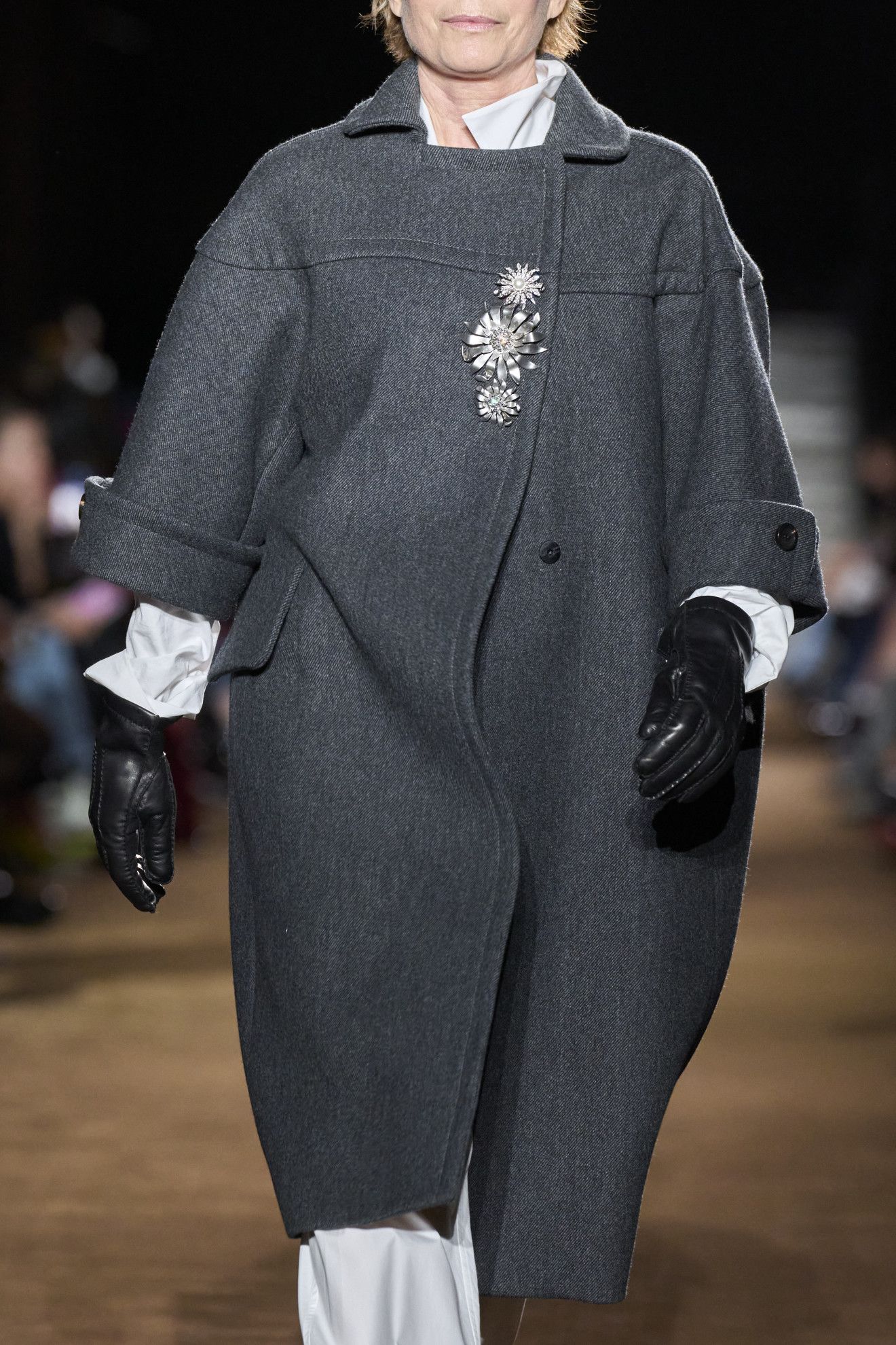 models wearing brooches on the runway