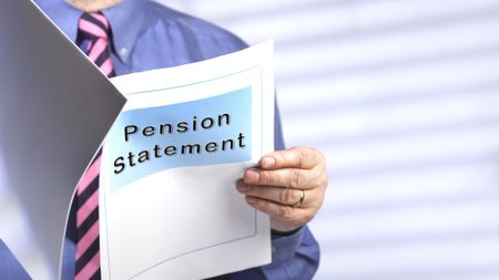 A man looks at his pension statement.