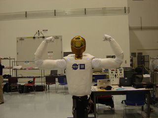 Robonaut 2 flexes for reporters before its upcoming launch to the International Space Station.