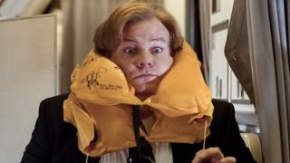 Tommy with an inflated life preserver choking him in Tommy Boy.