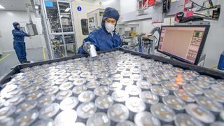 Technicians assemble sodium-ion battery units at a production facility in central China's Henan Province