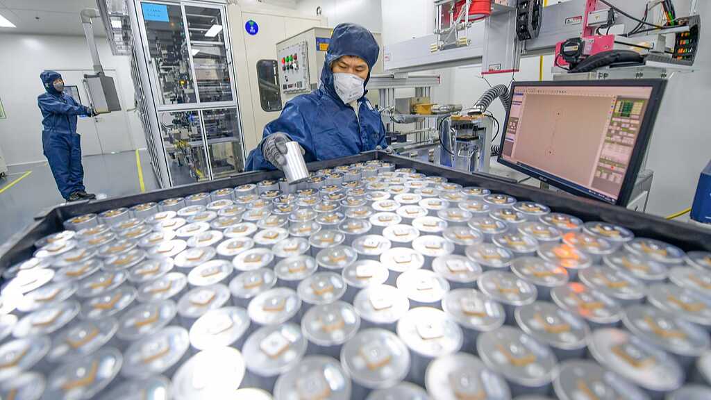 Technicians assemble sodium-ion battery units at a production facility in central China's Henan Province 