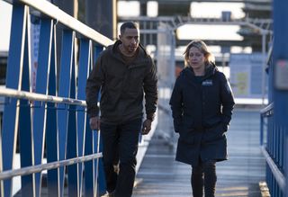 DS Tyrone Clarke (Ukweli Roach) and DI Annika Strandhed (Nicola Walker) walking along a gangway
